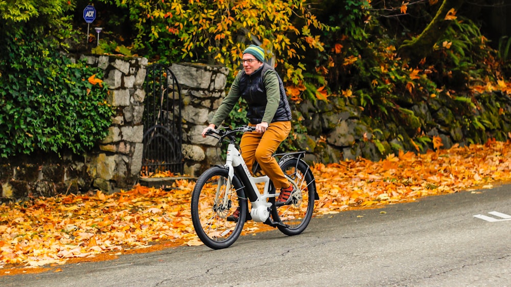 a man riding a bike down a street