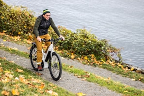 A happy recipient riding their new bike through a park