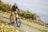 A happy customer riding a bike along a scenic road.