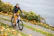 A satisfied customer riding their newly purchased used bike along a scenic Düsseldorf path.