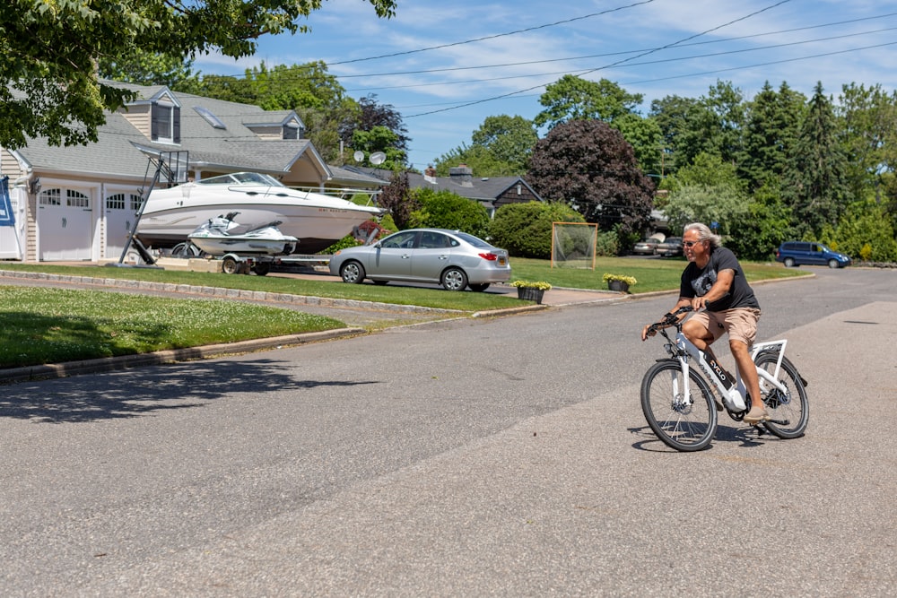 a man riding a bike down the middle of a street