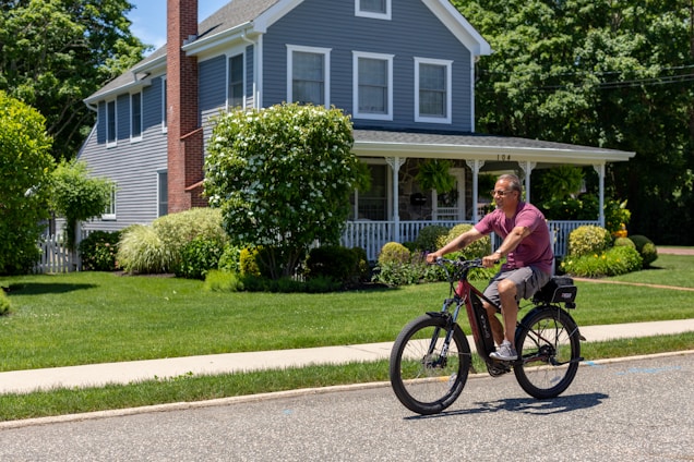 A joyful 74-year-old rider cruising on a sleek Meta Eunorau ebike through scenic Ottawa streets.