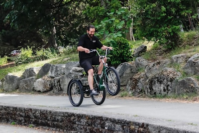 A specially abled individual using the tricycle in a park.