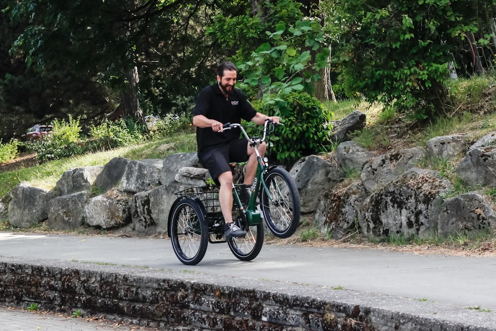 a man riding a bike down a street