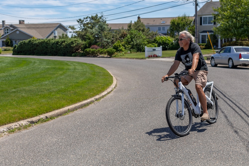 a man riding a bike down a curvy street