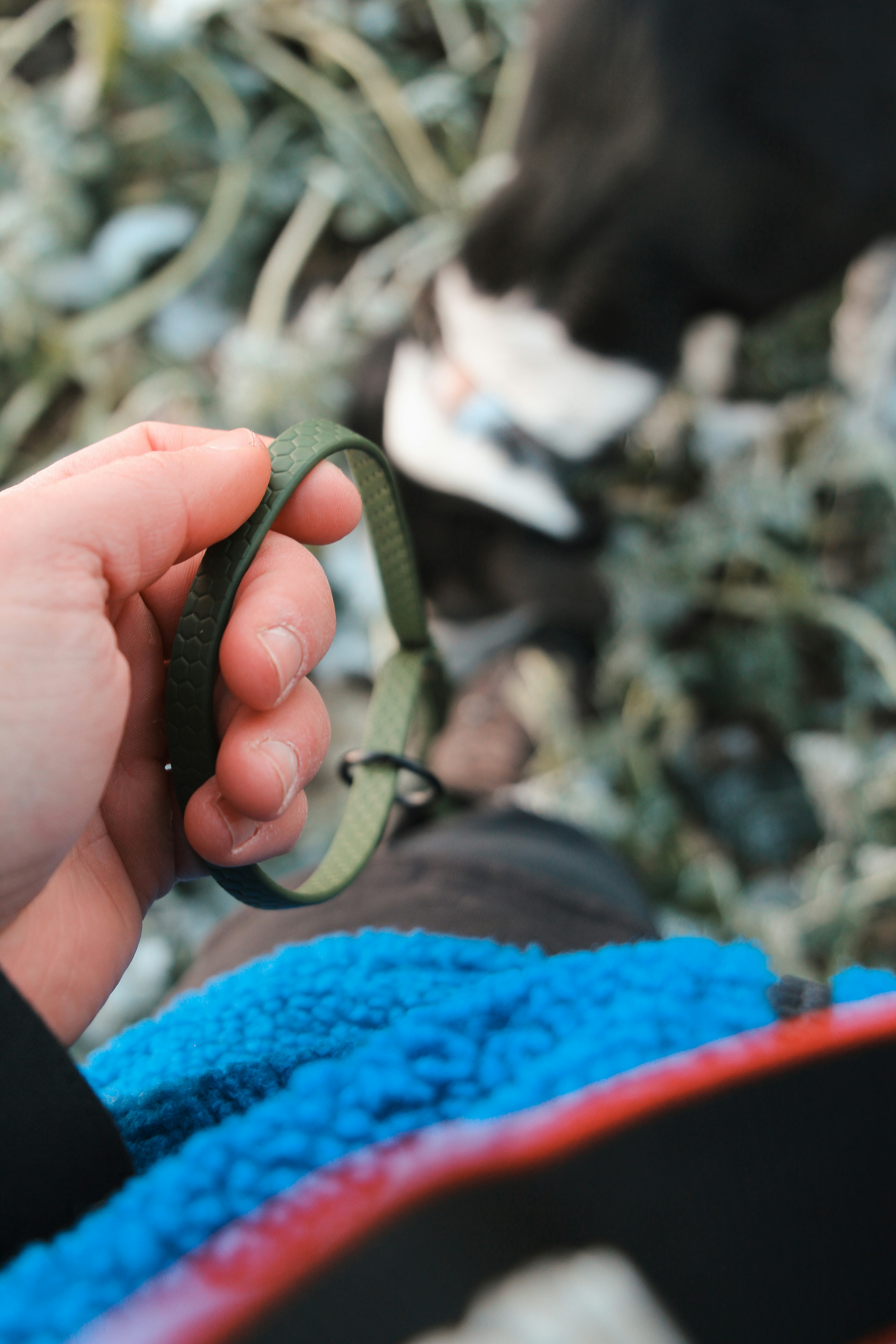 a person holding a green ribbon in their hand
