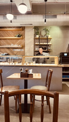 Cozy café interior with wooden tables and fresh beverages on display