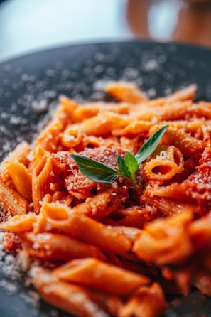 a close up of a plate of food with pasta