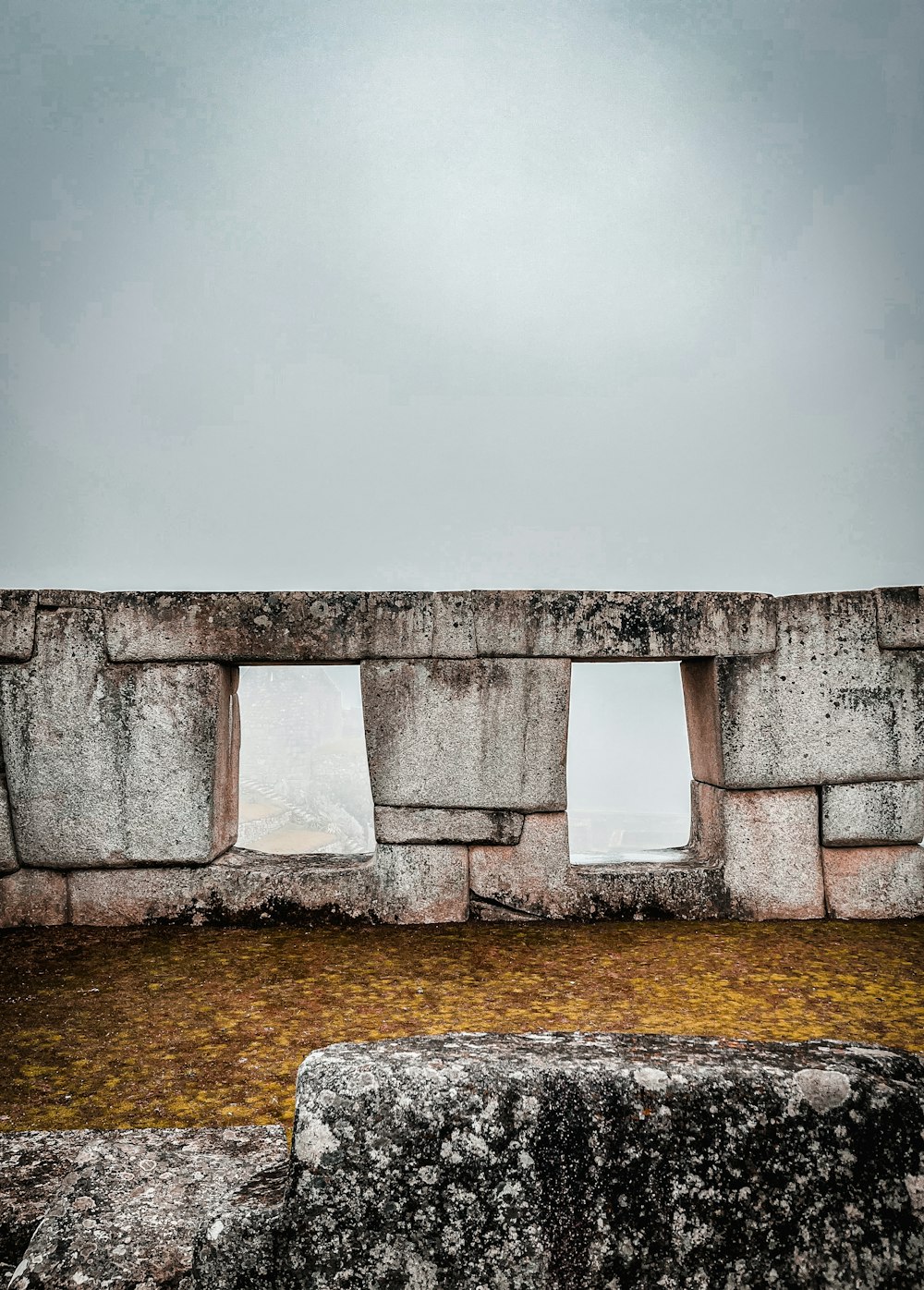 a stone structure with three windows on top of it