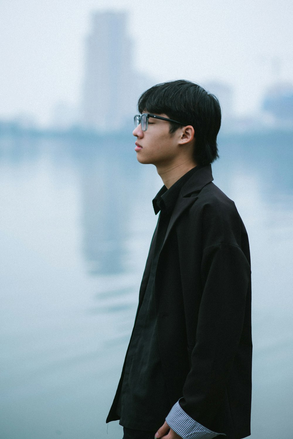 a man standing in front of a body of water