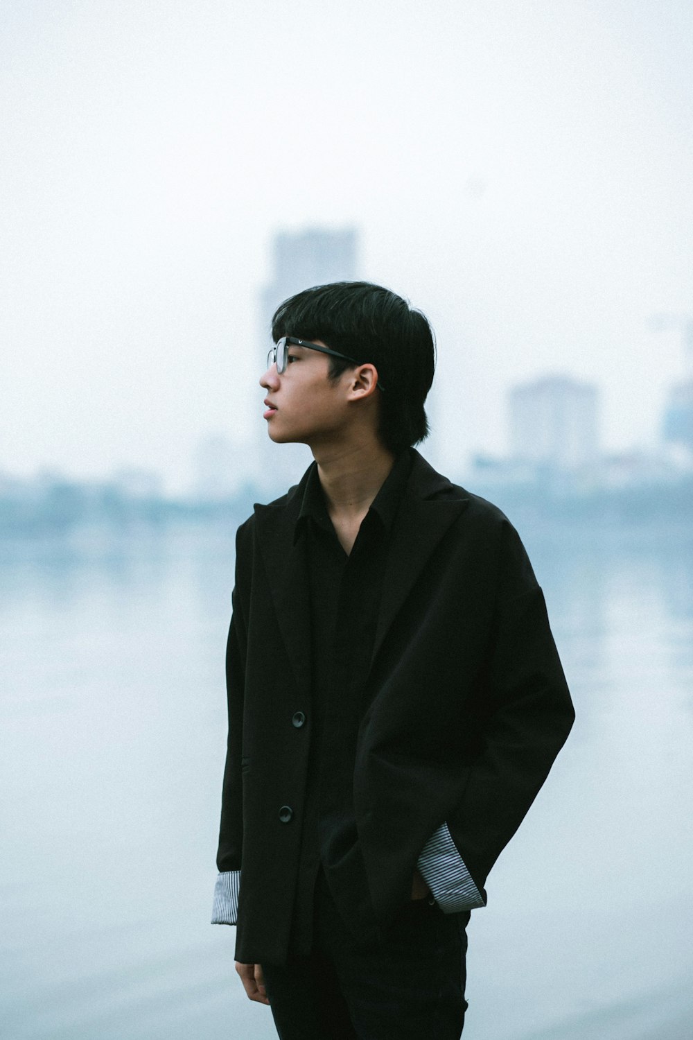 a man standing in front of a body of water