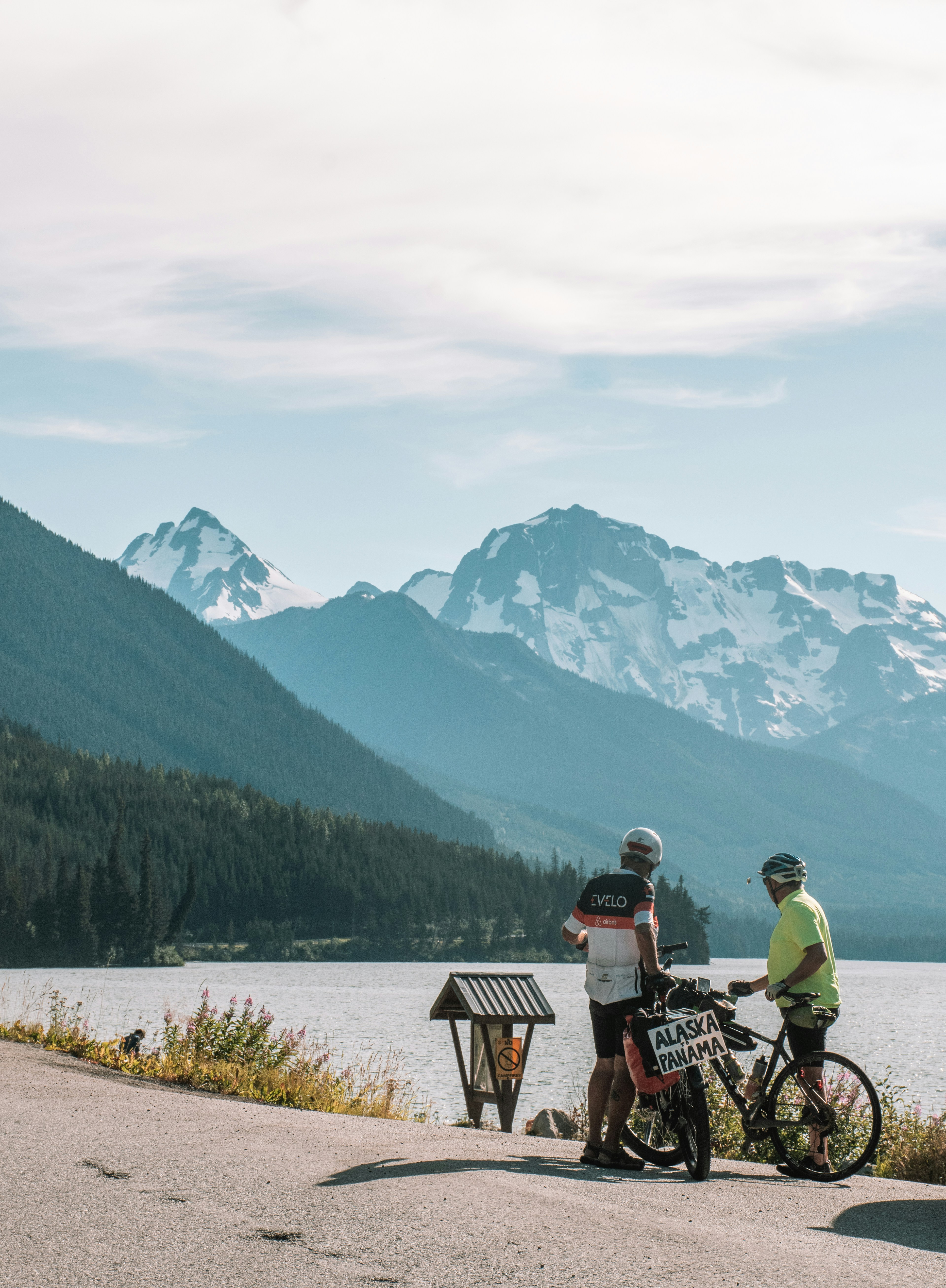 a couple of people that are standing next to a bike