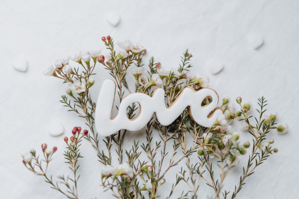 the word love spelled with letters surrounded by flowers