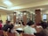 A diverse group of students discussing study plans around a table in a bright room.