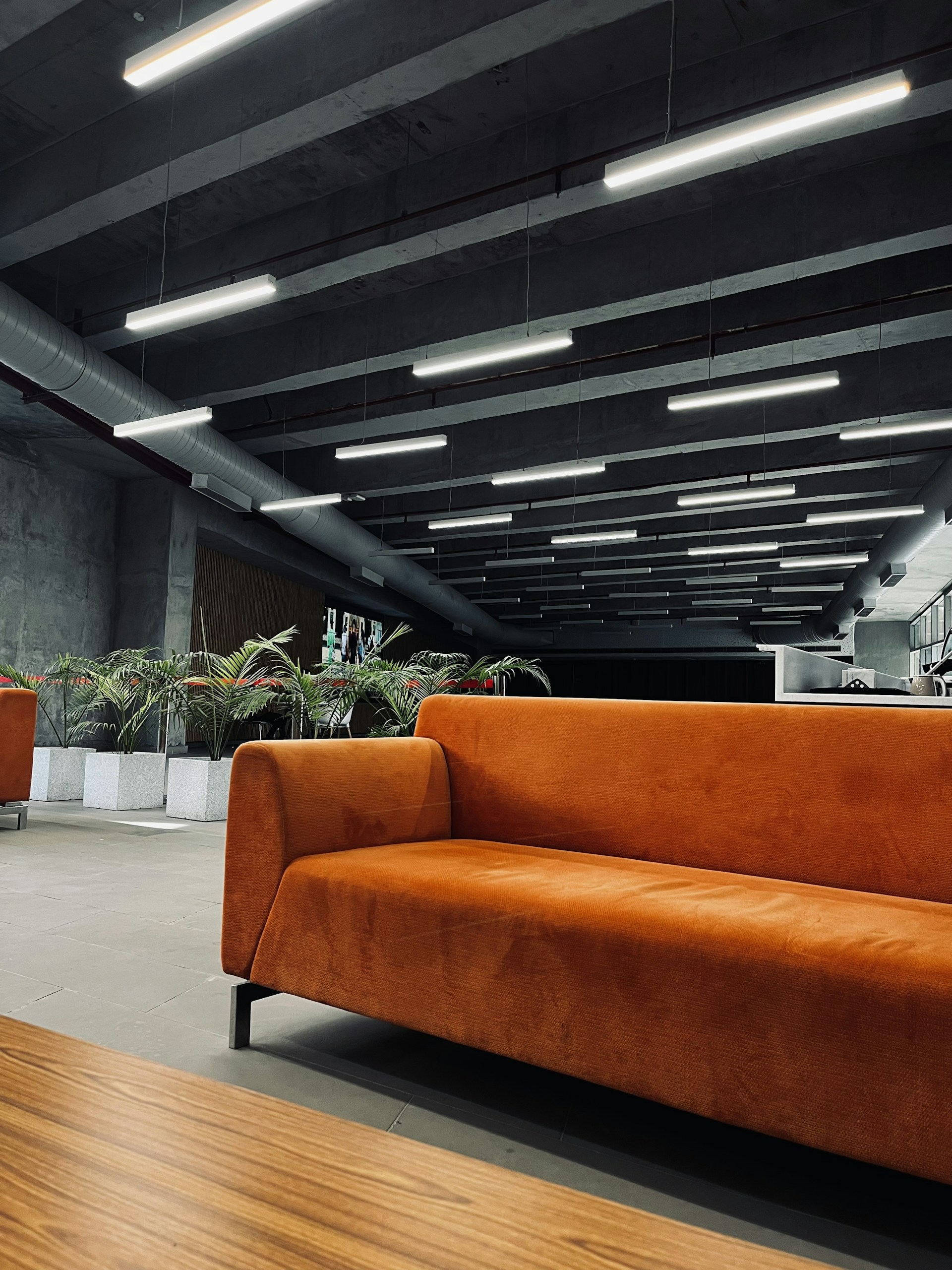 an orange couch sitting in a large room