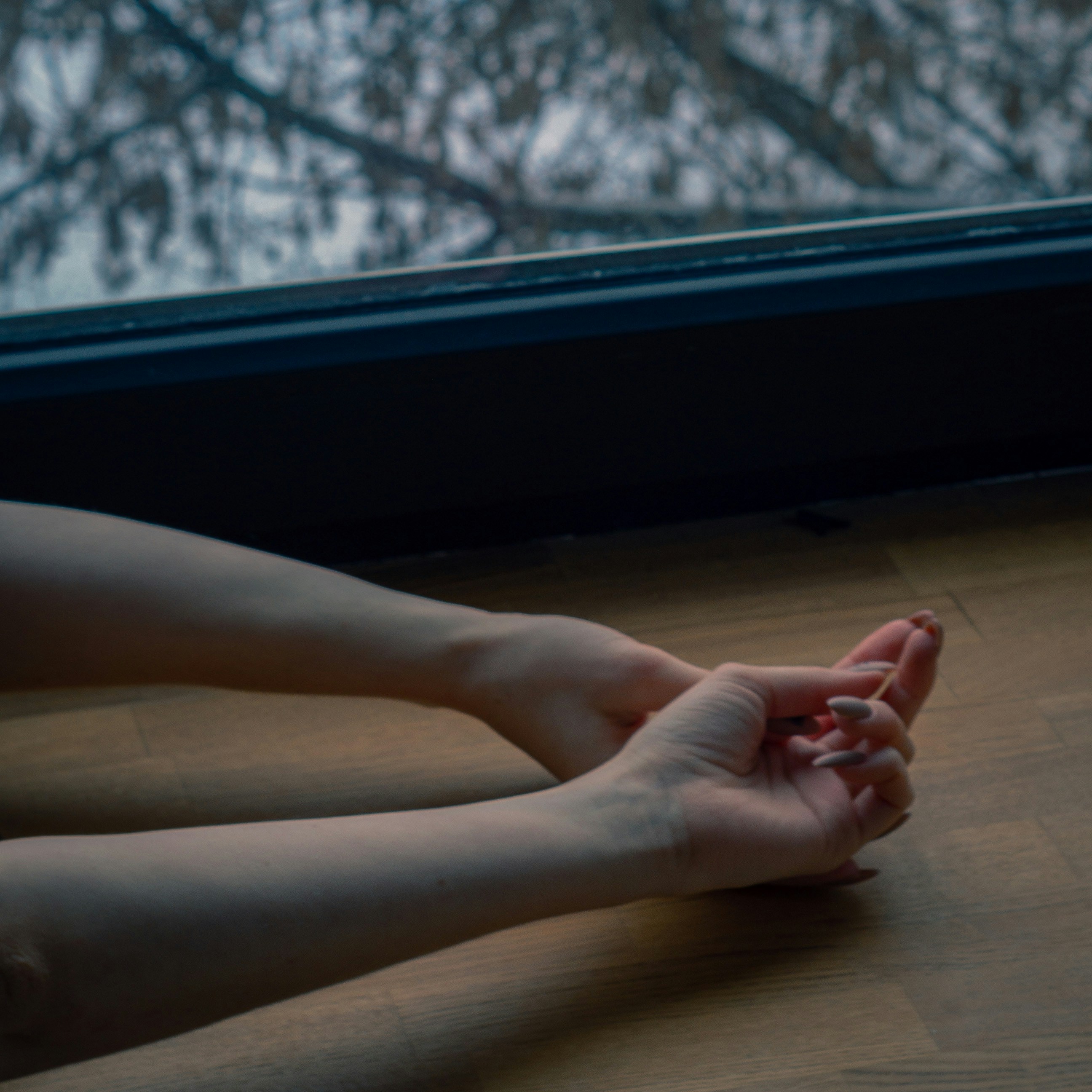 a person sitting on the floor with their legs crossed