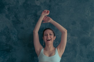 a woman with her arms up in the air