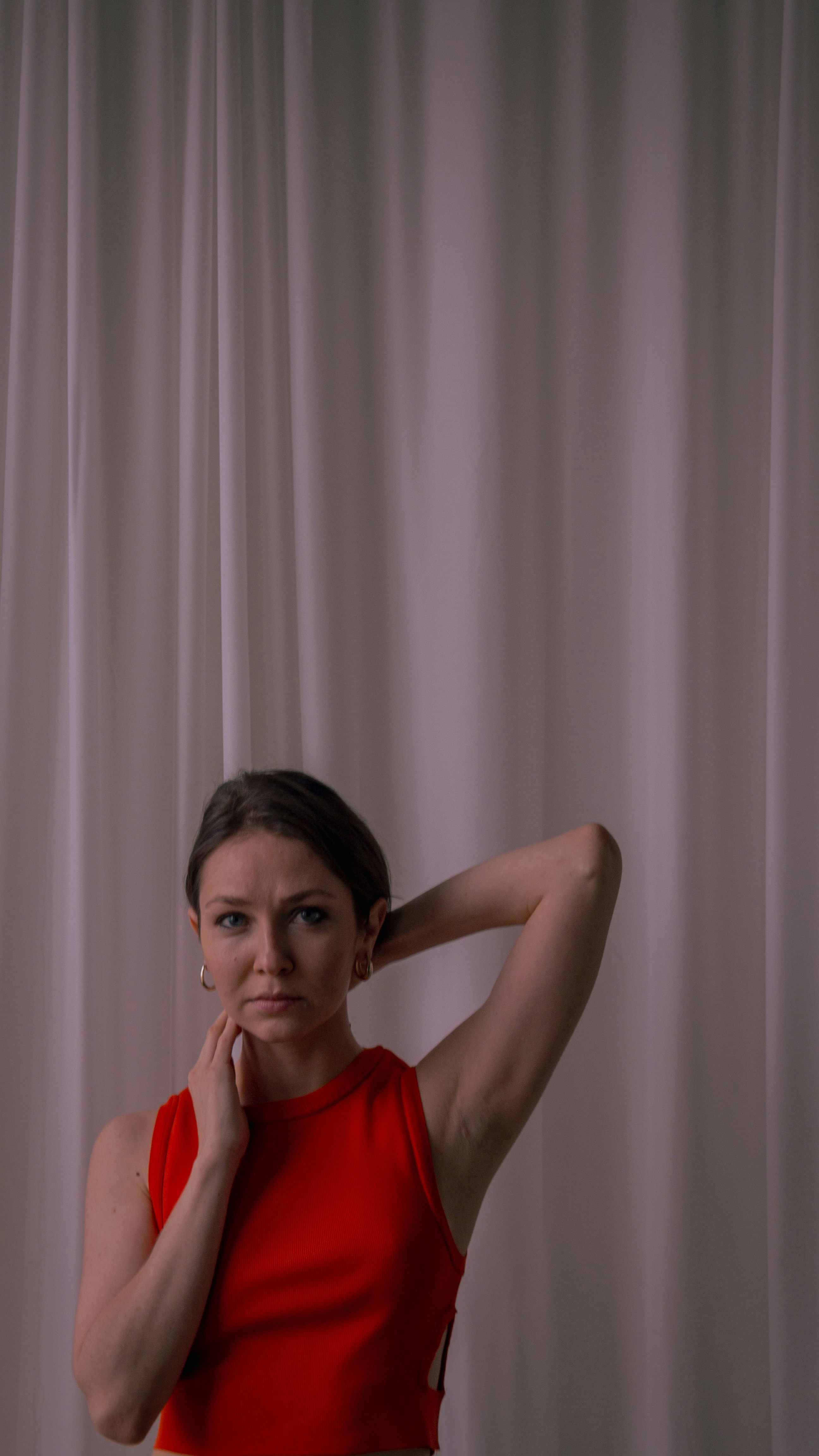 a woman in a red top posing for a picture