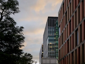 a couple of tall buildings sitting next to each other