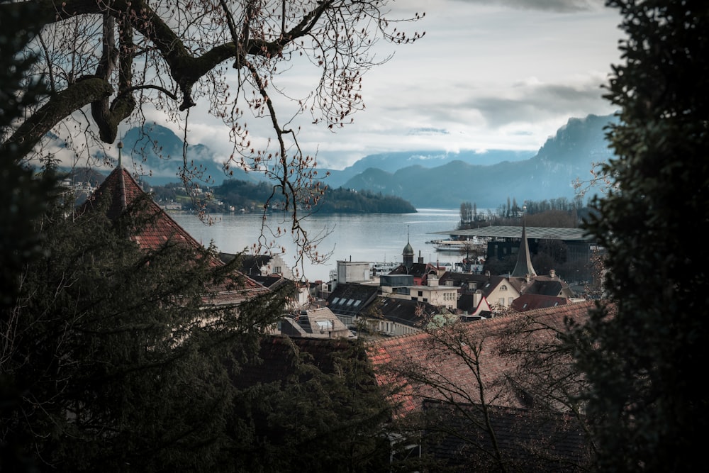 a view of a town with a lake and mountains in the background