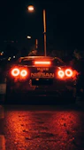 Nighttime street scene highlighting cars equipped with bright, clear auto lights.