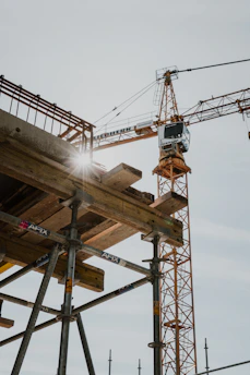 a crane is standing on top of a building under construction