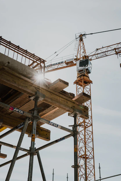 a crane is standing on top of a building under construction