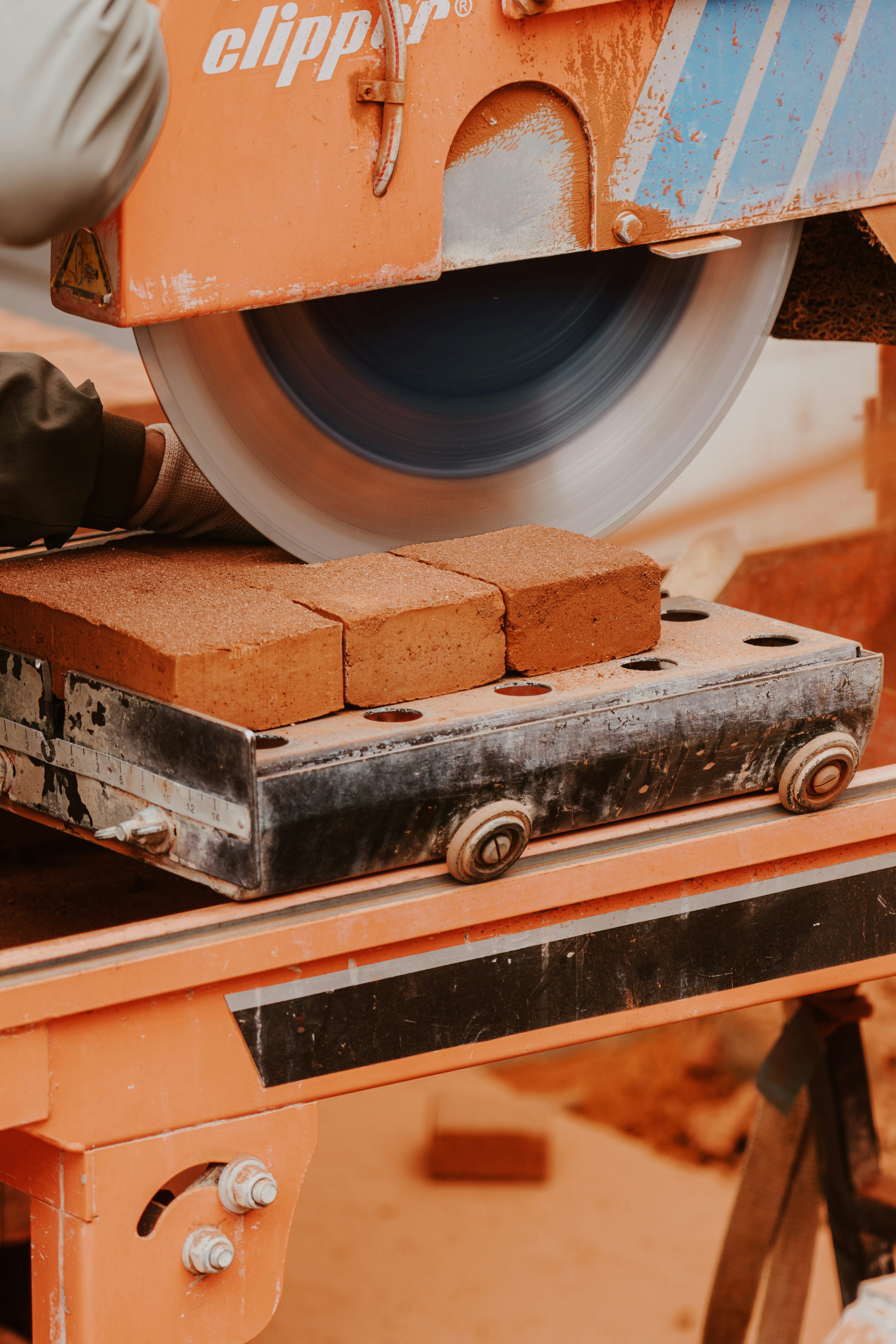 a person using a circular saw to cut bricks