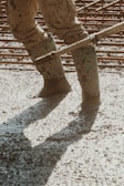 the legs of a person in muddy boots