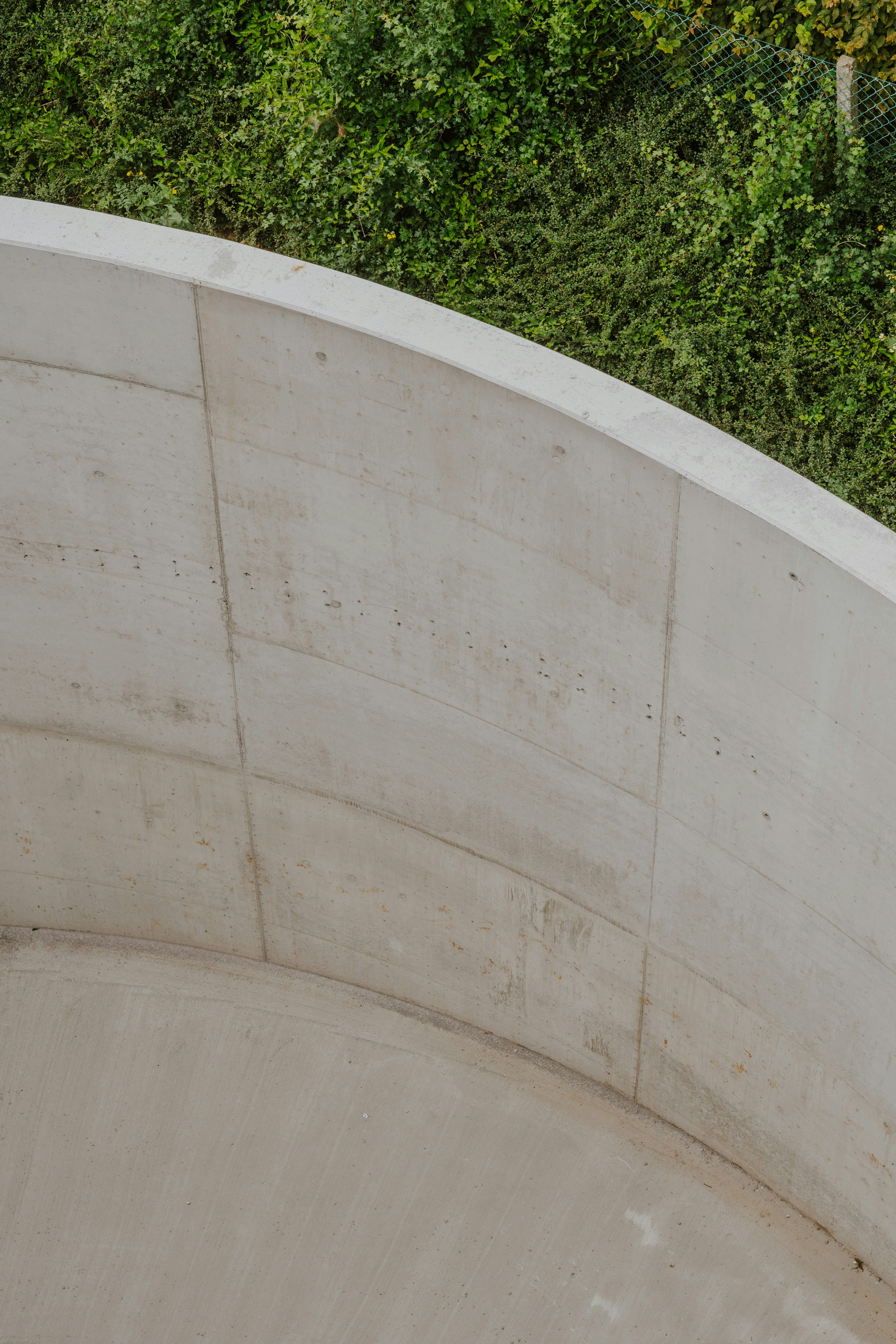 a man riding a skateboard up the side of a cement ramp