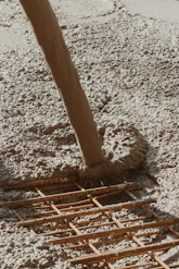 a wooden pole laying on top of a sandy beach