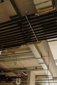 a room with a bunch of pipes and a clock