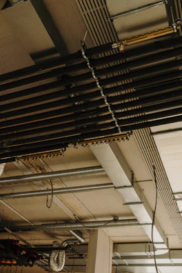 a room with a bunch of pipes and a clock