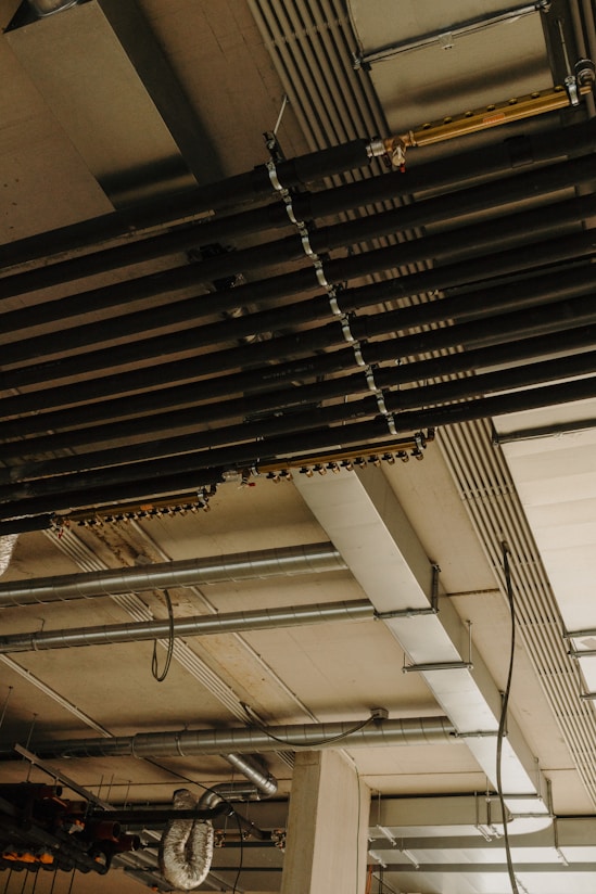 a room with a bunch of pipes and a clock