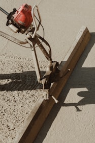 a red and black machine on a sidewalk