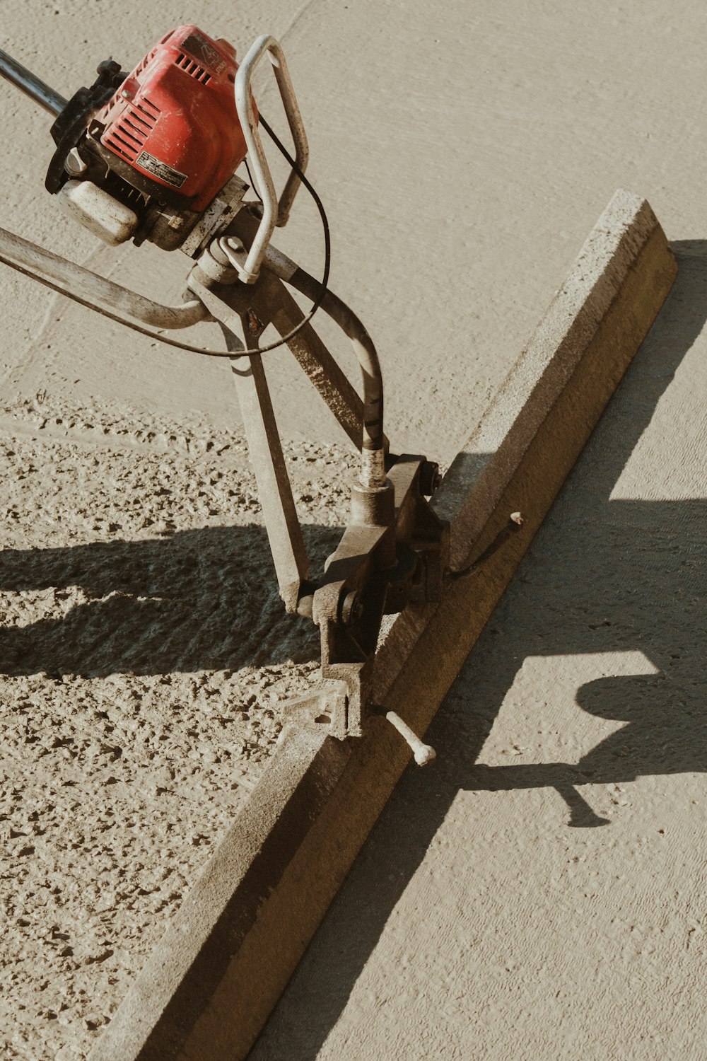 a red and black machine on a sidewalk