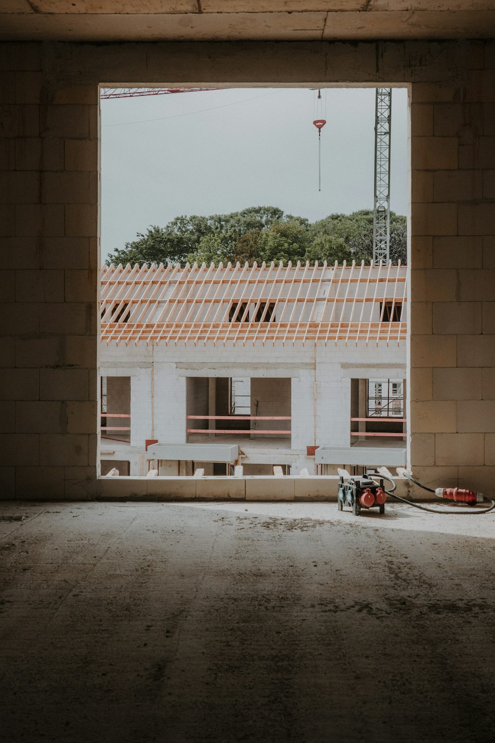 a building under construction with a crane in the background