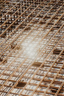 Reinforcement bars forming a complex grid, ready for the next phase of structural work under bright site lights.