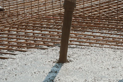 a man standing next to a building under construction