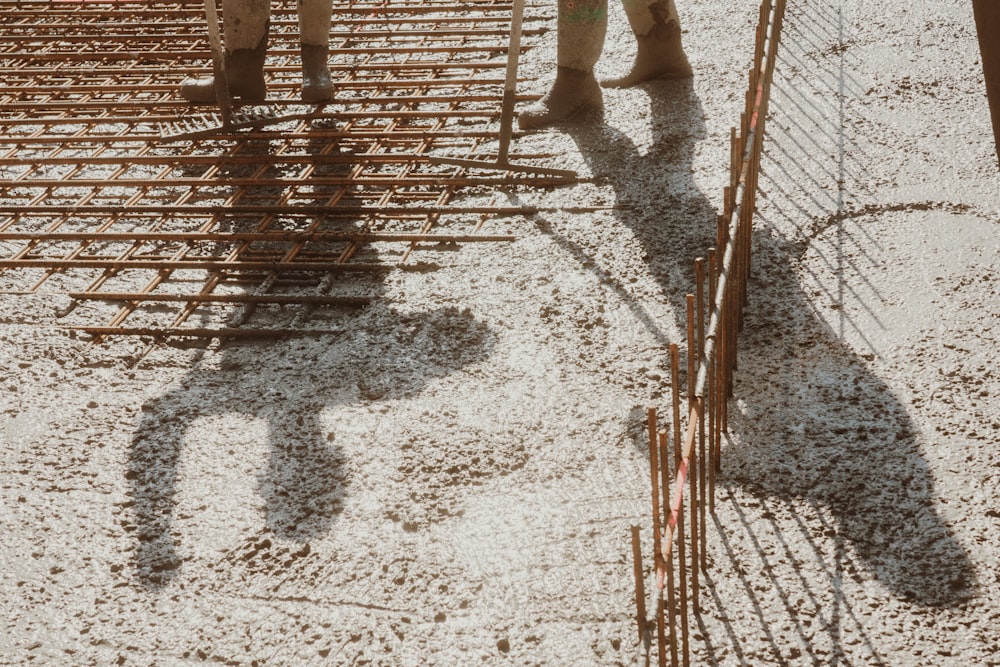 a man standing next to a pile of cages