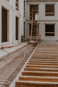 a building under construction with a stair case in the foreground