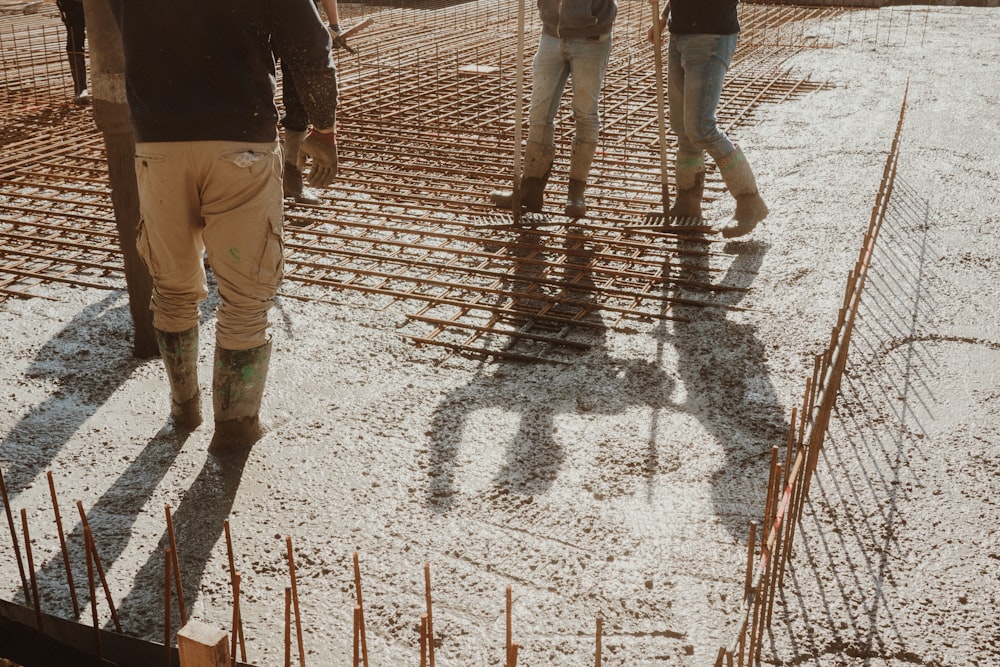 a group of people walking across a construction site