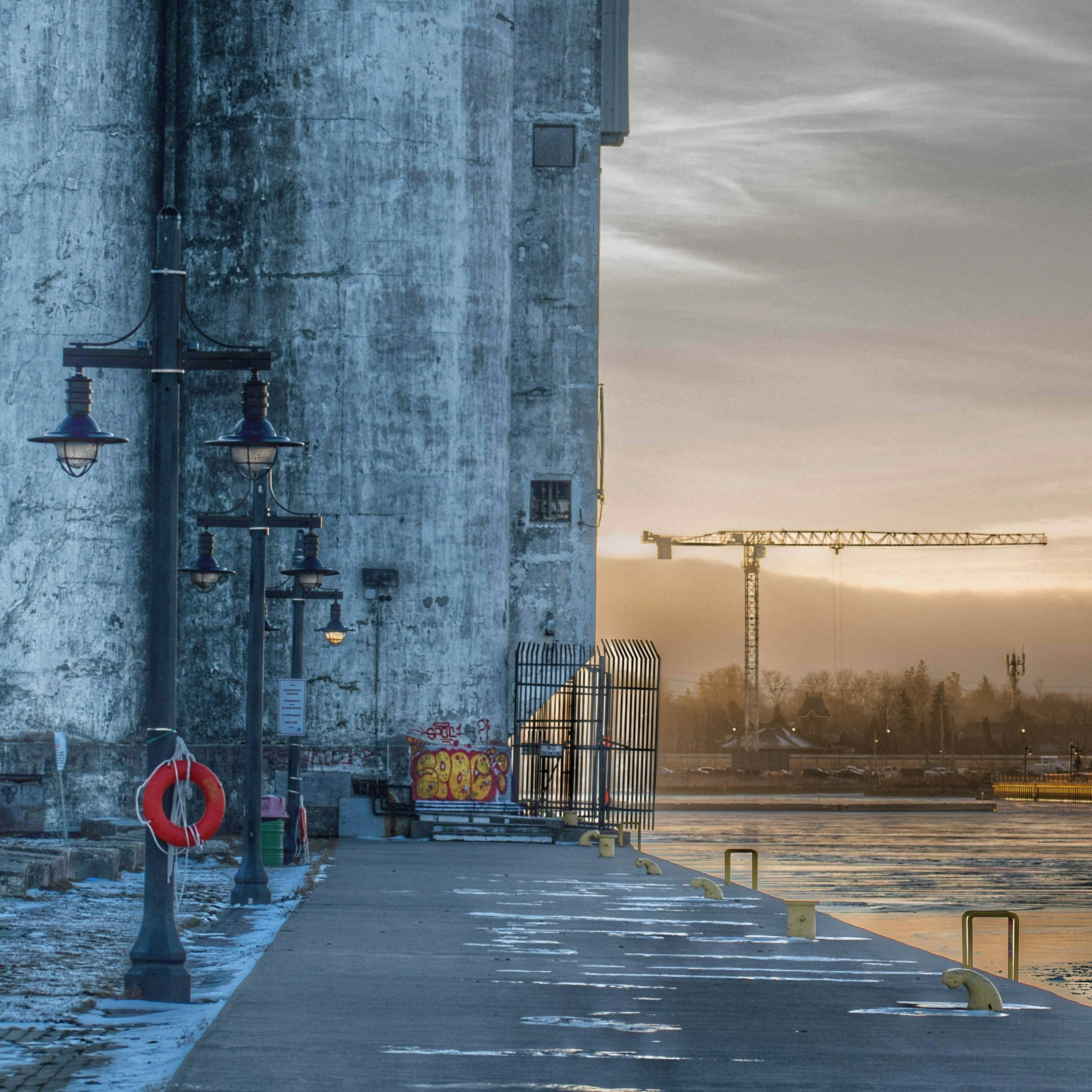a concrete building next to a body of water