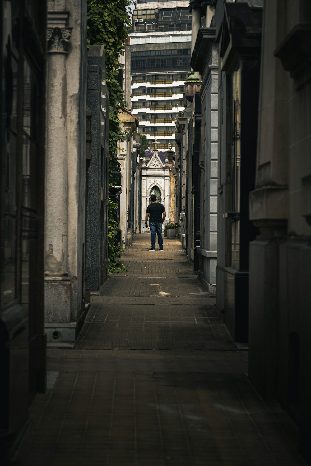 a person walking down a narrow alley way