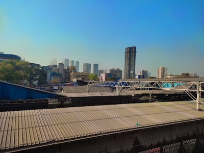 A cityscape featuring industrial buildings with clear skies in the background.
