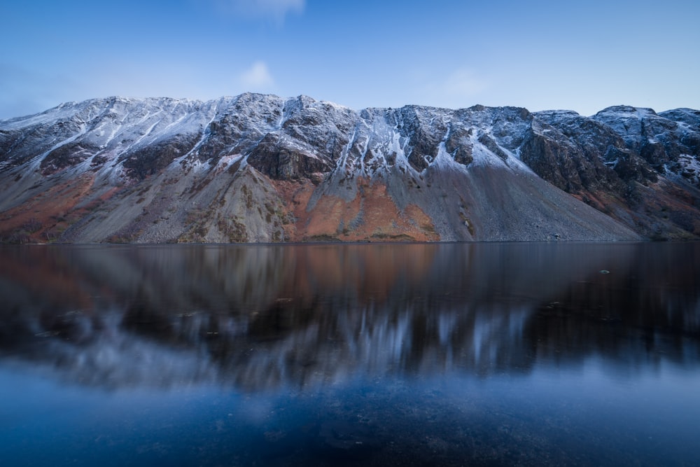 a mountain range with a body of water in front of it