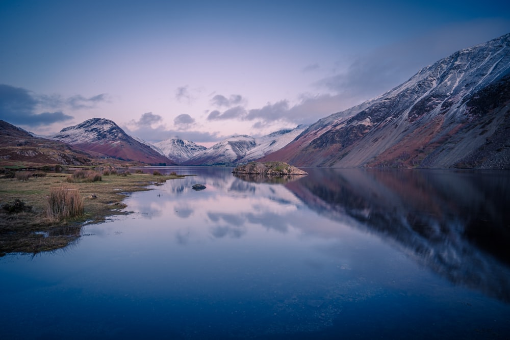 a lake with mountains in the background