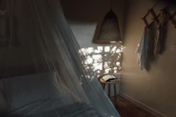 Soft bedroom nook with layered textiles and natural light.