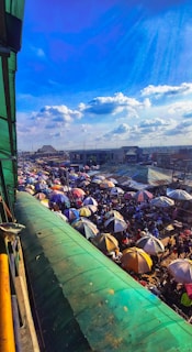 An early morning market scene with locals setting up stalls under vibrant umbrellas in Tlalpan.