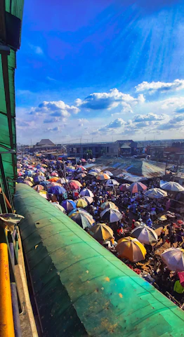 Lively outdoor market in Philadelphia bustling under colorful umbrellas.